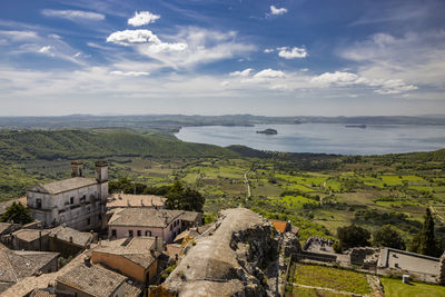 High angle view of townscape by sea against sky