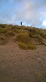 Scenic view of sand dunes against sky