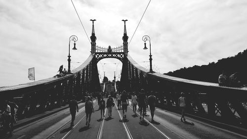 View of suspension bridge against cloudy sky