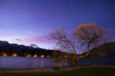 Scenic view of lake against sky at night