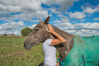 Horse hugged by