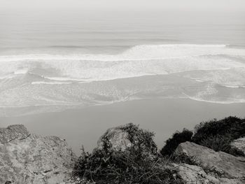 High angle view of land and sea against mountain