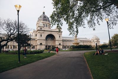 Road leading towards royal exhibition building against sky