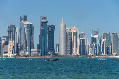 Sea with skyscrapers in background