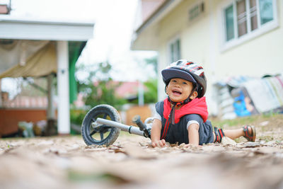 Boy fallen by bicycle on land