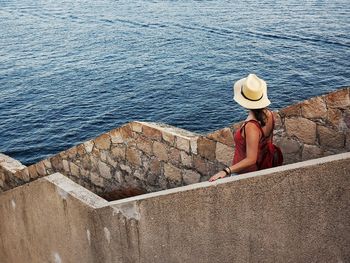 High angle view of woman walking on steps against sea