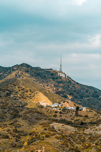 Scenic view of building and mountains against sky