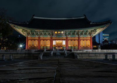 Illuminated building against sky at night