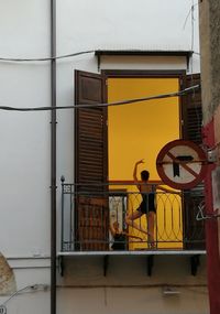 Man in yellow building