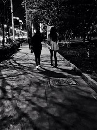 Woman standing on footpath