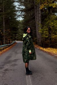 Full length of woman standing on road