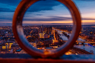 Aerial view of buildings in city at sunset