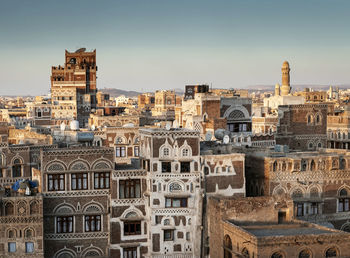 Old buildings in city against clear sky