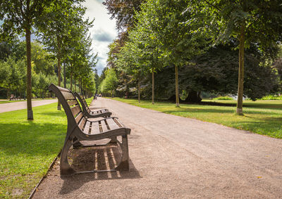 Benches in park against sky