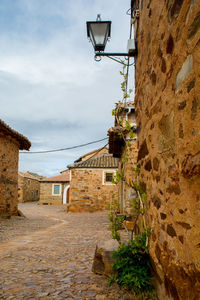 Alley amidst buildings against sky