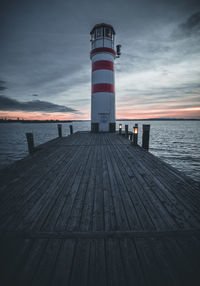 Pier over sea against sky during sunset