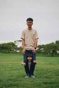 Parent and child standing on grass