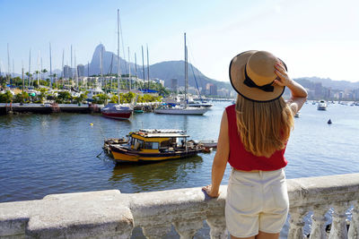 Rear view of woman standing at harbor in rio de janeiro