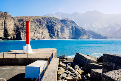 Scenic view of sea and mountains against sky