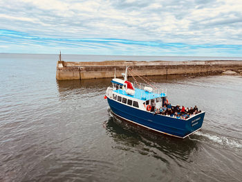 Boat sailing past the harbour wall