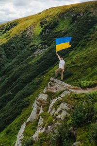 Rear view of man standing on mountain