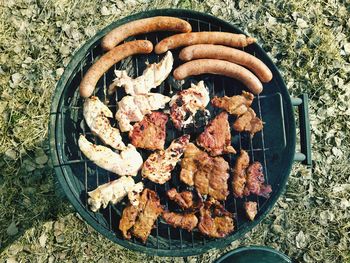 High angle view of meat on barbecue grill