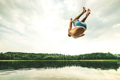 Woman jumping in lake