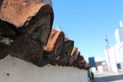 Close-up of rusty metal against sky