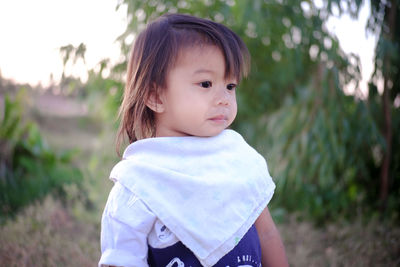 Portrait of cute girl standing on land