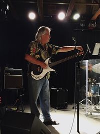 Man playing guitar at music concert