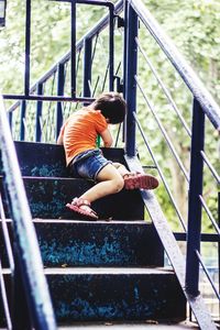 Woman standing by railing