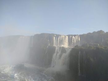 Scenic view of waterfall against sky