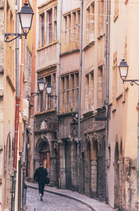 Full length of woman walking in alley