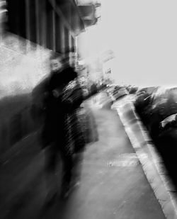 Blurred motion of people walking on street in city