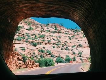 Rocky mountains seen through tunnel from car windshield