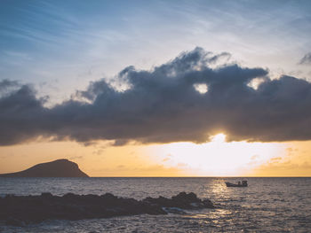 Sunrise scene at sea with clouds covering the sun