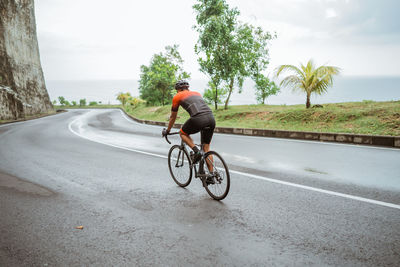 Man riding bicycle on road