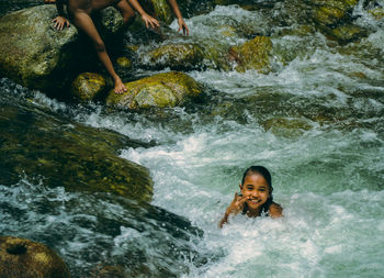 Portrait of girl showing victory sign at geruntum falls