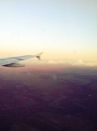 Cropped image of airplane flying over landscape