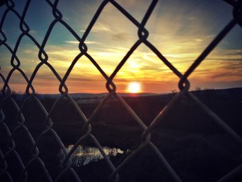 Chainlink fence at sunset