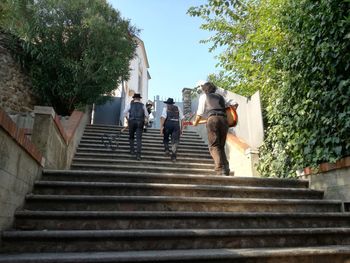 Low angle view of people walking up stairs