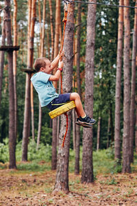 Full length rear view of young man in forest