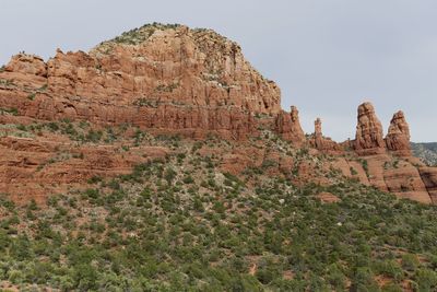 Low angle view of rocks on mountain against sky