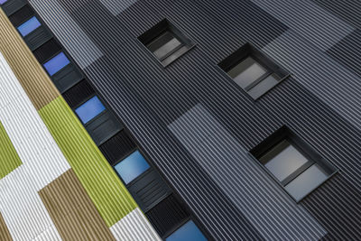 Low angle view of modern building against blue sky