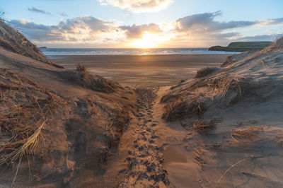 Scenic view of beach against sky during sunset
