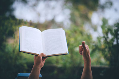 Midsection of person holding book