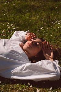 Midsection of man lying on grassy field