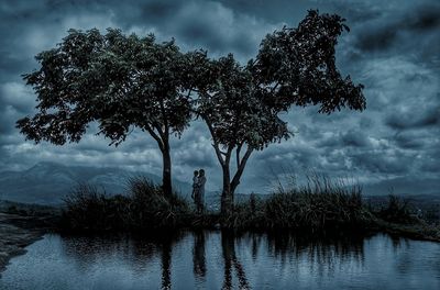 Reflection of trees in lake against sky