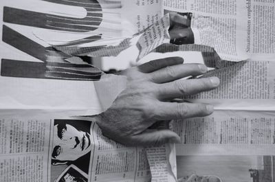 Close-up of hand holding book on table