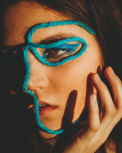 Close-up portrait of woman with blue eye make-up